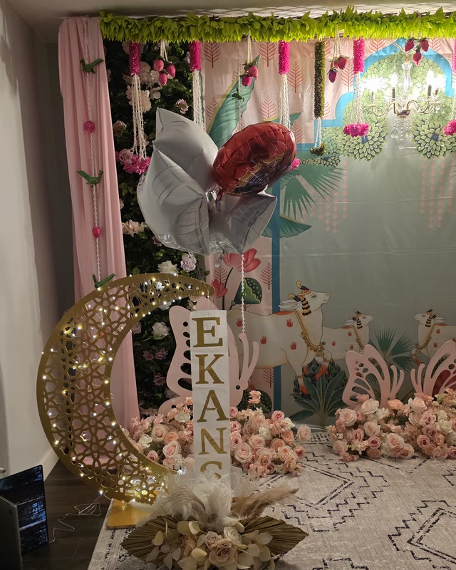 Pastel birthday backdrop with a gold moon arch, marquee name letters and balloons