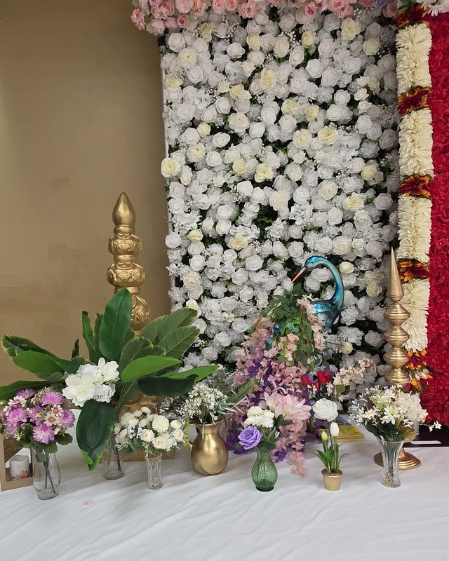 White and pink floral wall with brass vases and fresh greenery